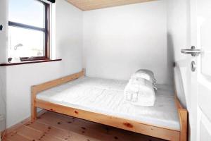 a bed in a small room with a window at K19109-Sejero-Vestervej-43 in Sejerby