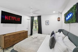 a bedroom with a bed and a tv on the wall at Upscale 4BR Residence Quick Access to Downtown in Austin