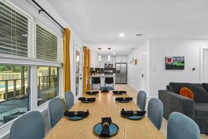 a dining room with a table and a living room at Upscale 4BR Residence Quick Access to Downtown in Austin