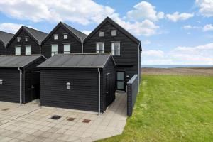 a house with black siding and a lawn at 20413-Samso-Ballen-Strandpark-16 in Ballen