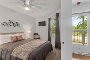 a bedroom with a bed and a ceiling fan at Shared Hot Tub & Pool Grill River Access in New Braunfels +19 photos
