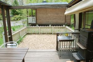 a patio with a grill and a wooden deck at Kitakaruizawa Sweet Grass - Vacation STAY 18432v in Kita-karuizawa