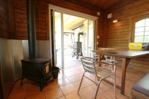 a dining room with a wood stove and a table at Kitakaruizawa Sweet Grass - Vacation STAY 18432v in Kita-karuizawa