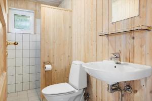 a bathroom with a white toilet and a sink at 20137-Samso-Topmejsevej-8 in Nordby