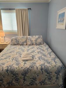 a bed with a white towel on it in a bedroom at Amenities and beach access! in Hilton Head Island