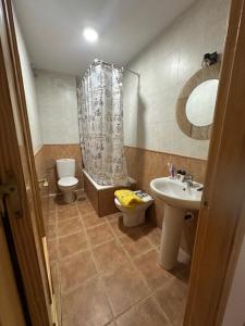 a bathroom with a sink and a toilet and a shower at Piso alcaucin in Alcaucín +5 photos
