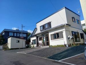a large white house with a driveway at Dai2Hokusuiryo - Vacation STAY 19357 in Sapporo