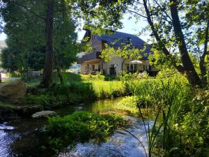 a house with a stream in front of it at O'Toole's, Plitvice in Korenica