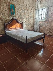a bed in a room with a brick wall at QingQing民宿 in Moncarapacho