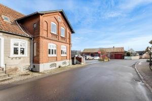 an empty street in front of a brick building at AE306-Marstal-Skovgyden-28 in Marstal