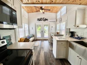 a kitchen with white cabinets and a ceiling fan at Resort at Fredericksburg Unit 4 in Rocky Hill