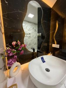 a bathroom with a white toilet and a mirror at Пентхаус in Dushanbe