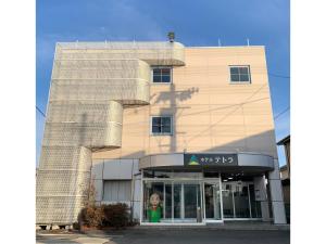 a building with a child in the doorway of it at Hotel Tetora Honhachinohe - Vacation STAY 97886v in Hachinohe
