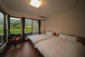 Ένα ή περισσότερα κρεβάτια σε δωμάτιο στο Yufudakeroten Nanafushi - Vacation STAY 62949v