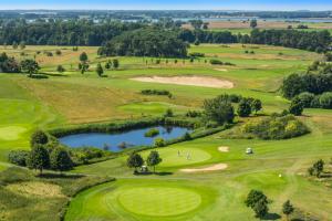 widok z powietrza na pole golfowe ze stawem w obiekcie Balmer See – Hotel•Golf•Spa w mieście Balm