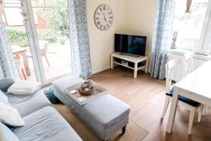 a living room with a couch and a tv at Zimt & Zucker in Langeoog