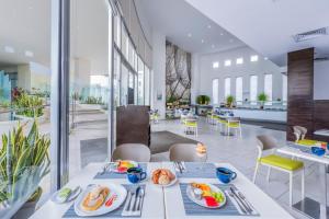 a dining room with a table with food on it at Krystal Urban Cancun & Beach Club in Cancún