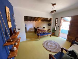 a living room with a blue couch and a table at Casa Praia in Luis Correia