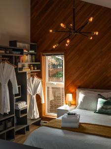 a bedroom with a bed and a window at Mid-Island Getaway - Sunken Hot Tub & Deck - Close to Beach - Modern in Nanaimo