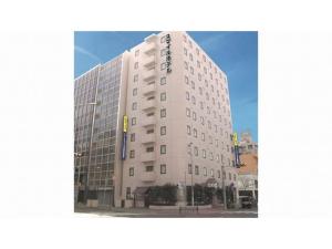 a tall white building with a sign on it at Smile Hotel Nagoya Shinkansenguchi - Vacation STAY 05079v in Nagoya