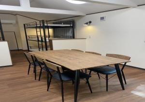 a room with a wooden table and chairs at Work Shop Camp Resort Forest and Lake Paradise - Vacation STAY 11809v in Fujikawaguchiko
