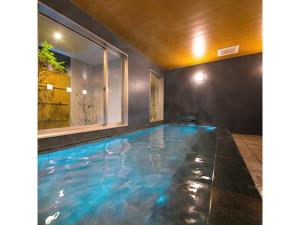 a large swimming pool with blue water in a house at Smile Hotel Anan - Vacation STAY 97690v in Anan