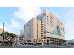 a large building on a street in a city at Smile Hotel Okinawa Naha - Vacation STAY 04109v in Naha