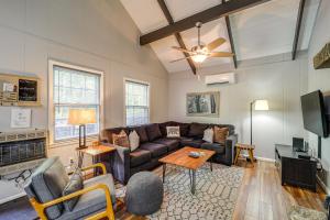 a living room with a couch and a tv at 'Bear Crossing Chalet:' Beech Mountain Family Home in Beech Mountain
