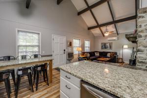 a kitchen and living room with a couch at 'Bear Crossing Chalet:' Beech Mountain Family Home in Beech Mountain