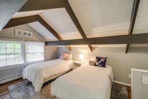 two beds in a room with a attic at 'Bear Crossing Chalet:' Beech Mountain Family Home in Beech Mountain