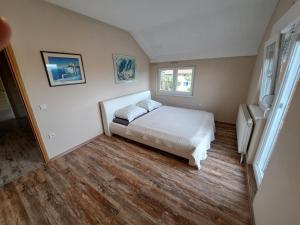 a bedroom with a bed and two windows at Villa Sunset in Banja Luka +116 photos