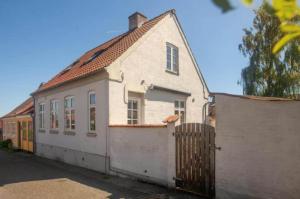 a white house with a fence in front of it at AE229-Marstal-Mellemgade-2 in Marstal