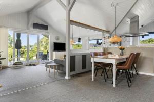 a living room with a dining room table and chairs at SB102-Sydals-Laerkemose-18 in Neder Lysabild