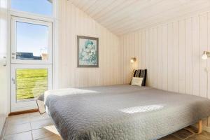 a bedroom with a bed and a large window at SB110-Nordborg-Sostjerneparken-36 in Nordborg