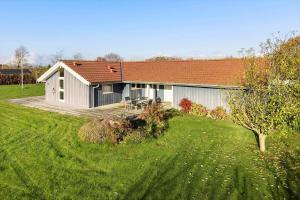 a white house with a deck in a yard at SB110-Nordborg-Sostjerneparken-36 in Nordborg +13 photos