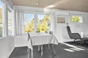 a white dining room with a table and two chairs at SB50628-Sydals-Egemose-131 in Skovmose
