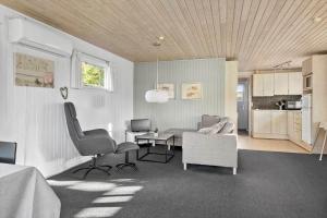 a living room with a couch and a table and chairs at SB50628-Sydals-Egemose-131 in Skovmose