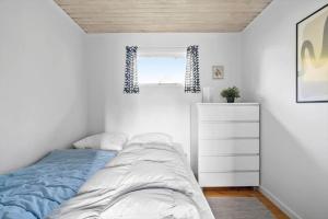 a bedroom with a bed and a dresser and a window at SB50628-Sydals-Egemose-131 in Skovmose