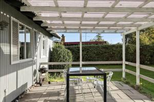 a patio with a table and chairs under a pergola at SB50628-Sydals-Egemose-131 in Skovmose +14 photos