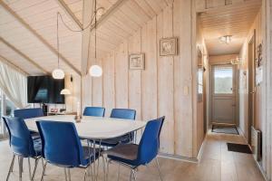 a dining room with a table and blue chairs at SB50389-Sydals-Harresbaek-20 in Sarup
