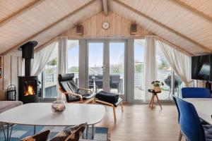 a living room with a table and chairs and a fireplace at SB50389-Sydals-Harresbaek-20 in Sarup