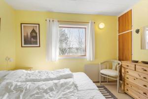 a bedroom with a bed and a window and a chair at SB50626-Sydals-Egemose-157 in Skovmose
