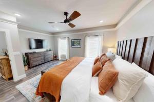 a bedroom with a large bed and a television at Gruene Retreat in New Braunfels