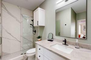 a bathroom with a sink and a shower and a mirror at Gruene Retreat in New Braunfels +26 photos