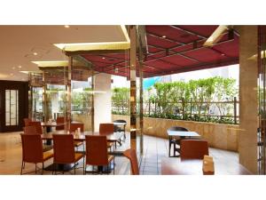a restaurant with tables and chairs in a building at Smile Hotel Naha City Resort - Vacation STAY 05994v in Naha