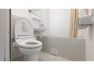 a white bathroom with a toilet and a bath tub at DIG the Osaka - Vacation STAY 96973v in Suita +14 photos