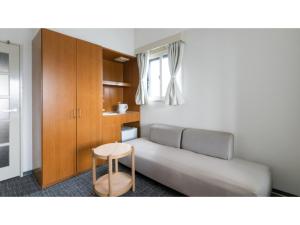 a living room with a couch and a table at DIG the Osaka - Vacation STAY 96978v in Suita