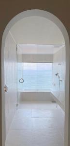 a bathroom with a shower with a view of the ocean at Abutagun - House - Vacation STAY 98370v in Usu