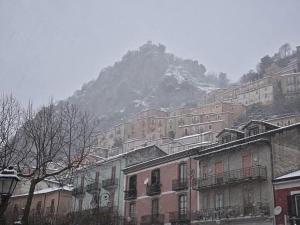 a group of buildings in front of a mountain at Tartufo hotel - COLLIANO- in Colliano