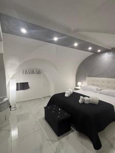 a bedroom with a large bed with a black blanket at La 75 Stella Home Catania in Catania